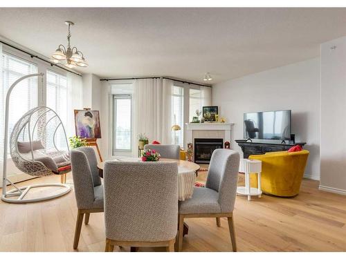 404-1726 14 Avenue Nw, Calgary, AB - Indoor Photo Showing Dining Room With Fireplace