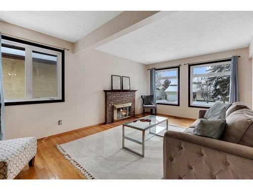 6724 Silverdale Road Nw, Calgary, AB - Indoor Photo Showing Living Room With Fireplace