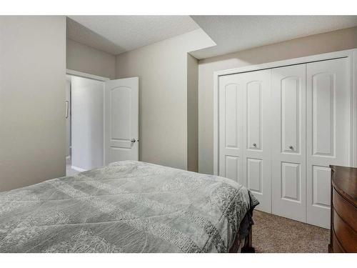 28 Jumping Pound Rise, Cochrane, AB - Indoor Photo Showing Bedroom