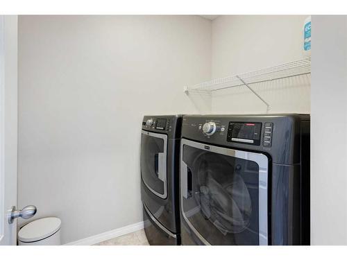 28 Jumping Pound Rise, Cochrane, AB - Indoor Photo Showing Laundry Room