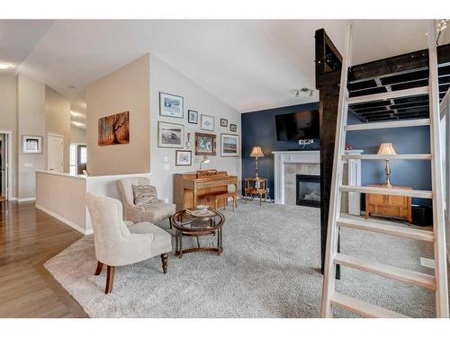 28 Jumping Pound Rise, Cochrane, AB - Indoor Photo Showing Living Room With Fireplace