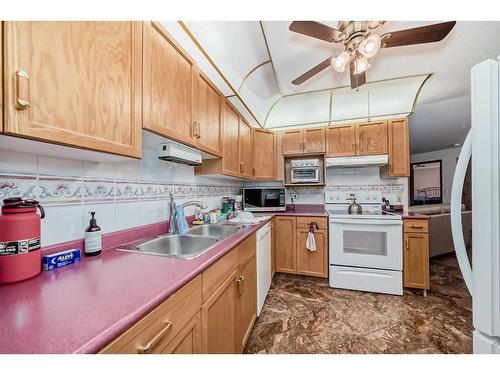 308-7239 Sierra Morena Boulevard Sw, Calgary, AB - Indoor Photo Showing Kitchen With Double Sink