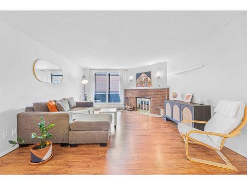 203-511 56 Avenue Sw, Calgary, AB - Indoor Photo Showing Living Room With Fireplace