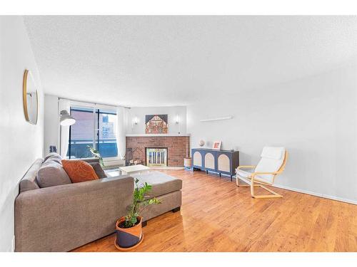 203-511 56 Avenue Sw, Calgary, AB - Indoor Photo Showing Living Room With Fireplace