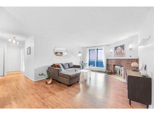 203-511 56 Avenue Sw, Calgary, AB - Indoor Photo Showing Living Room With Fireplace