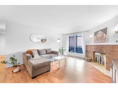 203-511 56 Avenue Sw, Calgary, AB - Indoor Photo Showing Living Room With Fireplace