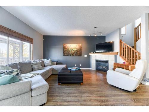 230 Tuscany Vista Road Nw, Calgary, AB - Indoor Photo Showing Living Room With Fireplace