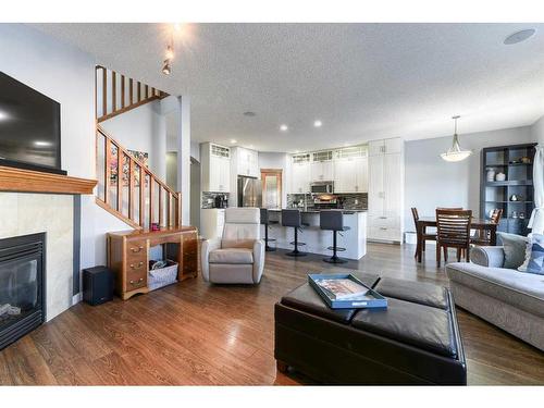 230 Tuscany Vista Road Nw, Calgary, AB - Indoor Photo Showing Living Room With Fireplace