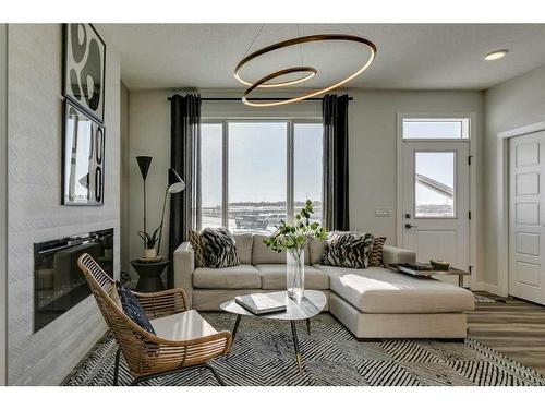 644 Buffaloberry Manor Se, Calgary, AB - Indoor Photo Showing Living Room With Fireplace