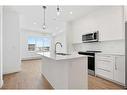 2403-111 Wolf Creek Drive Se, Calgary, AB  - Indoor Photo Showing Kitchen With Double Sink With Upgraded Kitchen 