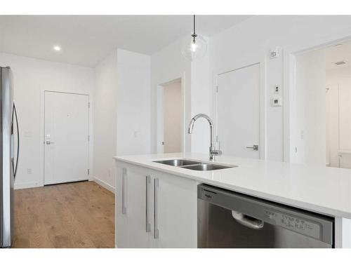 2403-111 Wolf Creek Drive Se, Calgary, AB - Indoor Photo Showing Kitchen With Double Sink With Upgraded Kitchen