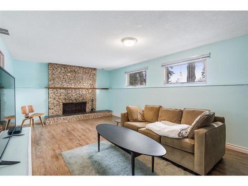 1132 Lake Sylvan Place Se, Calgary, AB - Indoor Photo Showing Living Room With Fireplace