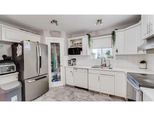 110 Taravista Drive Ne, Calgary, AB - Indoor Photo Showing Kitchen With Double Sink