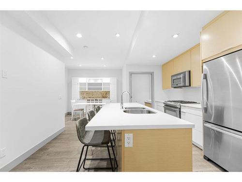 203-1707 27 Avenue Sw, Calgary, AB - Indoor Photo Showing Kitchen With Stainless Steel Kitchen With Double Sink With Upgraded Kitchen