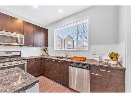 214 Copperpond Row Se, Calgary, AB - Indoor Photo Showing Kitchen With Stainless Steel Kitchen With Double Sink