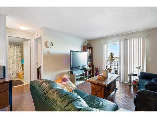 2217-6224 17 Avenue Se, Calgary, AB - Indoor Photo Showing Living Room With Fireplace