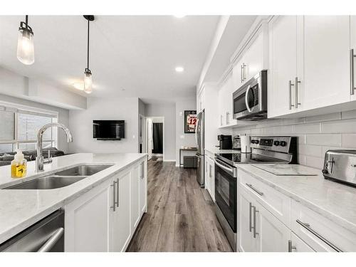 102-360 Harvest Hills Common Ne, Calgary, AB - Indoor Photo Showing Kitchen With Stainless Steel Kitchen With Double Sink With Upgraded Kitchen