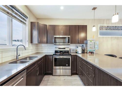 221 Seton Circle Se, Calgary, AB - Indoor Photo Showing Kitchen With Double Sink