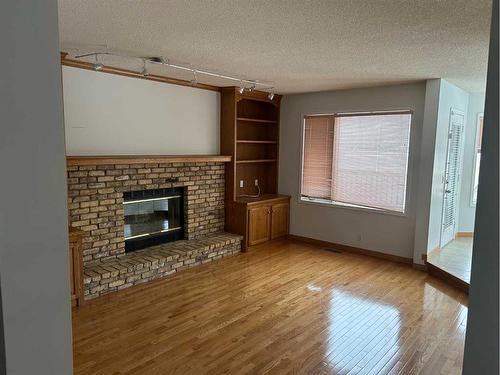 296 Edgebank Circle Nw, Calgary, AB - Indoor Photo Showing Living Room With Fireplace