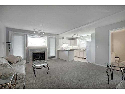 301-4507 45 Street Sw, Calgary, AB - Indoor Photo Showing Living Room With Fireplace