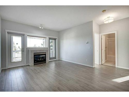 301-4507 45 Street Sw, Calgary, AB - Indoor Photo Showing Living Room With Fireplace