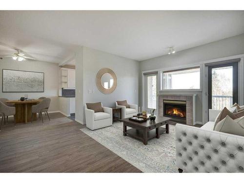 301-4507 45 Street Sw, Calgary, AB - Indoor Photo Showing Living Room With Fireplace