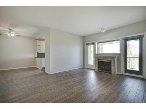 301-4507 45 Street Sw, Calgary, AB - Indoor Photo Showing Living Room With Fireplace