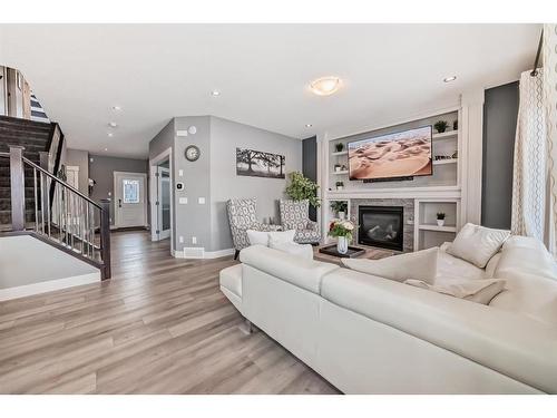 144 Baysprings Court Sw, Airdrie, AB - Indoor Photo Showing Living Room With Fireplace