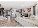 144 Baysprings Court Sw, Airdrie, AB  - Indoor Photo Showing Living Room With Fireplace 