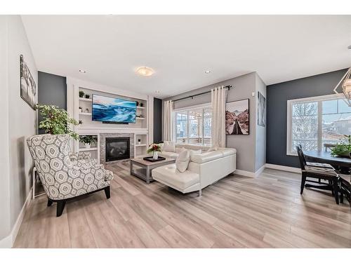 144 Baysprings Court Sw, Airdrie, AB - Indoor Photo Showing Living Room With Fireplace