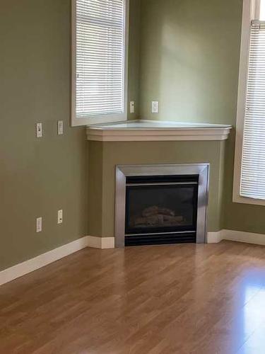 102-303 19 Avenue Sw, Calgary, AB - Indoor Photo Showing Living Room With Fireplace