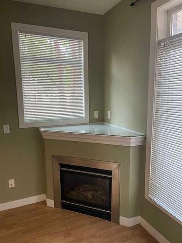 102-303 19 Avenue Sw, Calgary, AB - Indoor Photo Showing Living Room With Fireplace