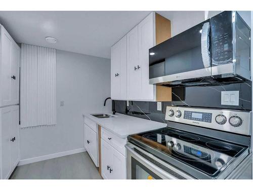 19 Marmot Way Nw, Calgary, AB - Indoor Photo Showing Kitchen With Double Sink