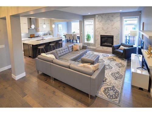 117 Aspenmere Bay, Chestermere, AB - Indoor Photo Showing Living Room With Fireplace