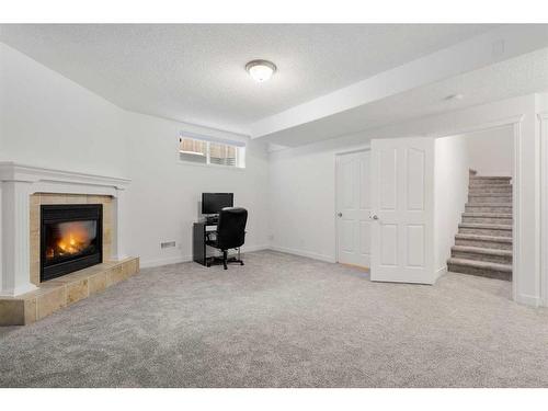 53 Strathlea Grove Sw, Calgary, AB - Indoor Photo Showing Other Room With Fireplace