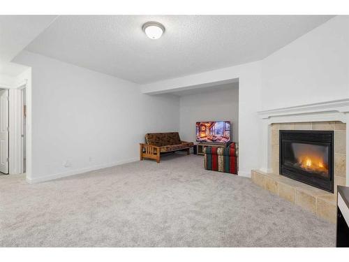 53 Strathlea Grove Sw, Calgary, AB - Indoor Photo Showing Other Room With Fireplace