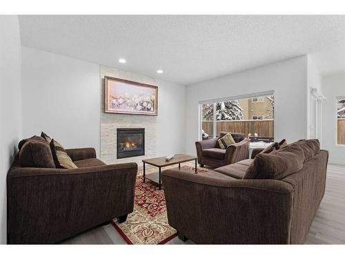 53 Strathlea Grove Sw, Calgary, AB - Indoor Photo Showing Living Room With Fireplace