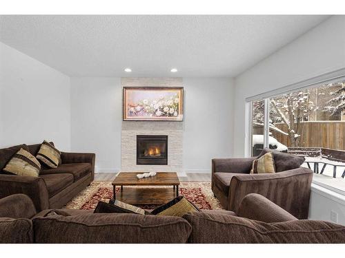 53 Strathlea Grove Sw, Calgary, AB - Indoor Photo Showing Living Room With Fireplace