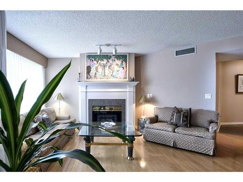 211-9449 19 Street Sw, Calgary, AB - Indoor Photo Showing Living Room With Fireplace