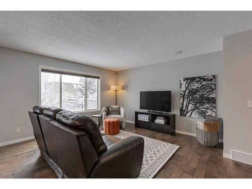 93 Cougarstone Place Sw, Calgary, AB - Indoor Photo Showing Living Room