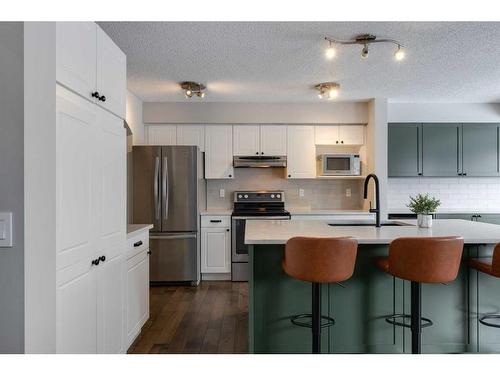 93 Cougarstone Place Sw, Calgary, AB - Indoor Photo Showing Kitchen With Double Sink