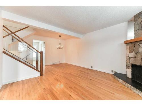 555 Woodpark Boulevard Sw, Calgary, AB - Indoor Photo Showing Other Room With Fireplace