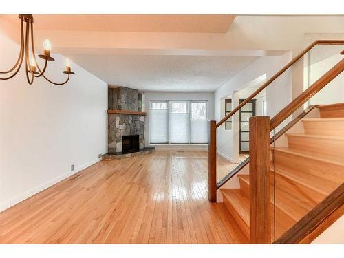 555 Woodpark Boulevard Sw, Calgary, AB - Indoor Photo Showing Other Room With Fireplace