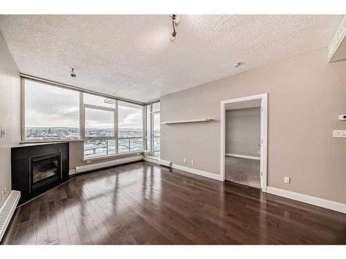 605-77 Spruce Place Sw, Calgary, AB - Indoor With Fireplace