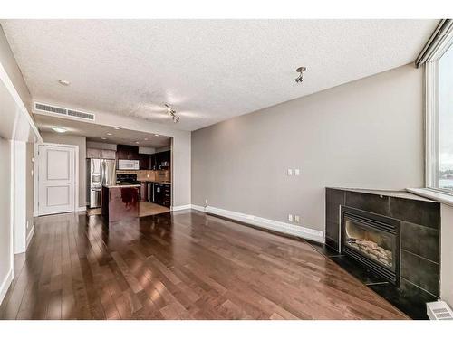 605-77 Spruce Place Sw, Calgary, AB - Indoor Photo Showing Other Room With Fireplace