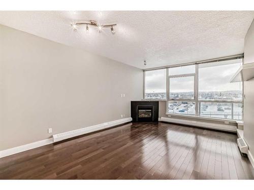 605-77 Spruce Place Sw, Calgary, AB - Indoor With Fireplace