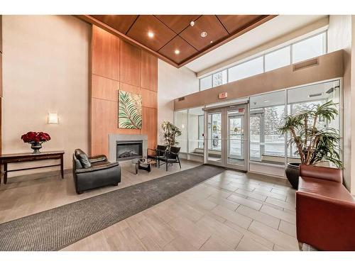 605-77 Spruce Place Sw, Calgary, AB - Indoor Photo Showing Other Room With Fireplace