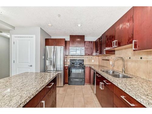 605-77 Spruce Place Sw, Calgary, AB - Indoor Photo Showing Kitchen With Stainless Steel Kitchen With Double Sink