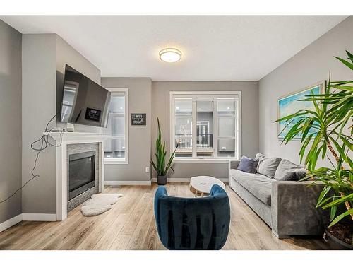 3-1930 26A Street Sw, Calgary, AB - Indoor Photo Showing Living Room With Fireplace