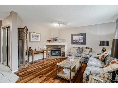 172 Tuscarora Heights Nw, Calgary, AB - Indoor Photo Showing Living Room With Fireplace